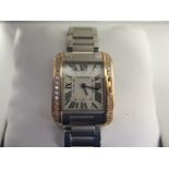 A ladies Cartier steel rose gold and diamond tank wristwatch, rectangular case, silvered face with