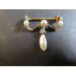A 9ct gold pearl and diamond brooch with three small round pearls, a baroque pendant pearl and a