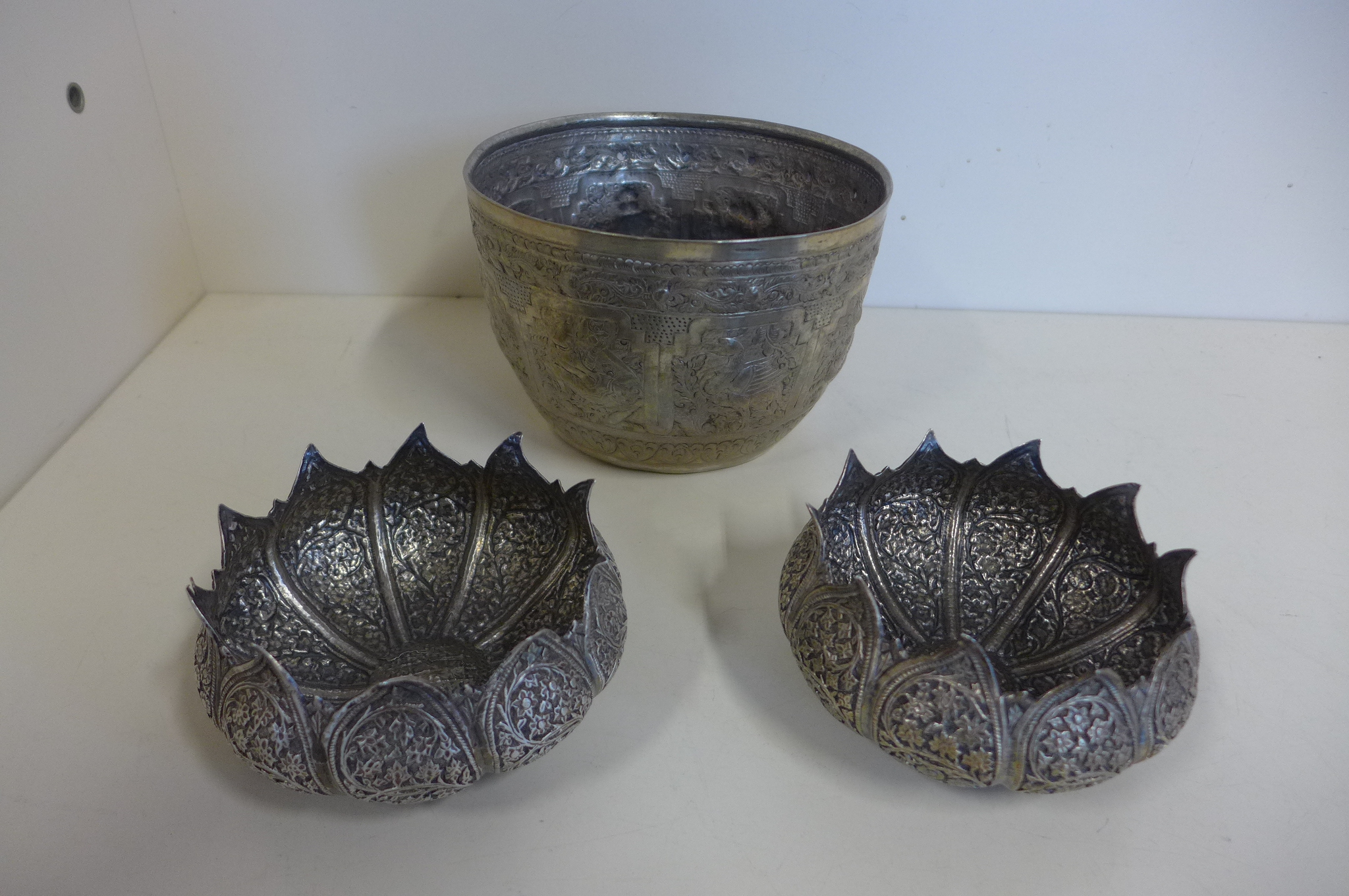 A pair of silver Eastern bowls, together with an early low grade silver bowl, height of tallest