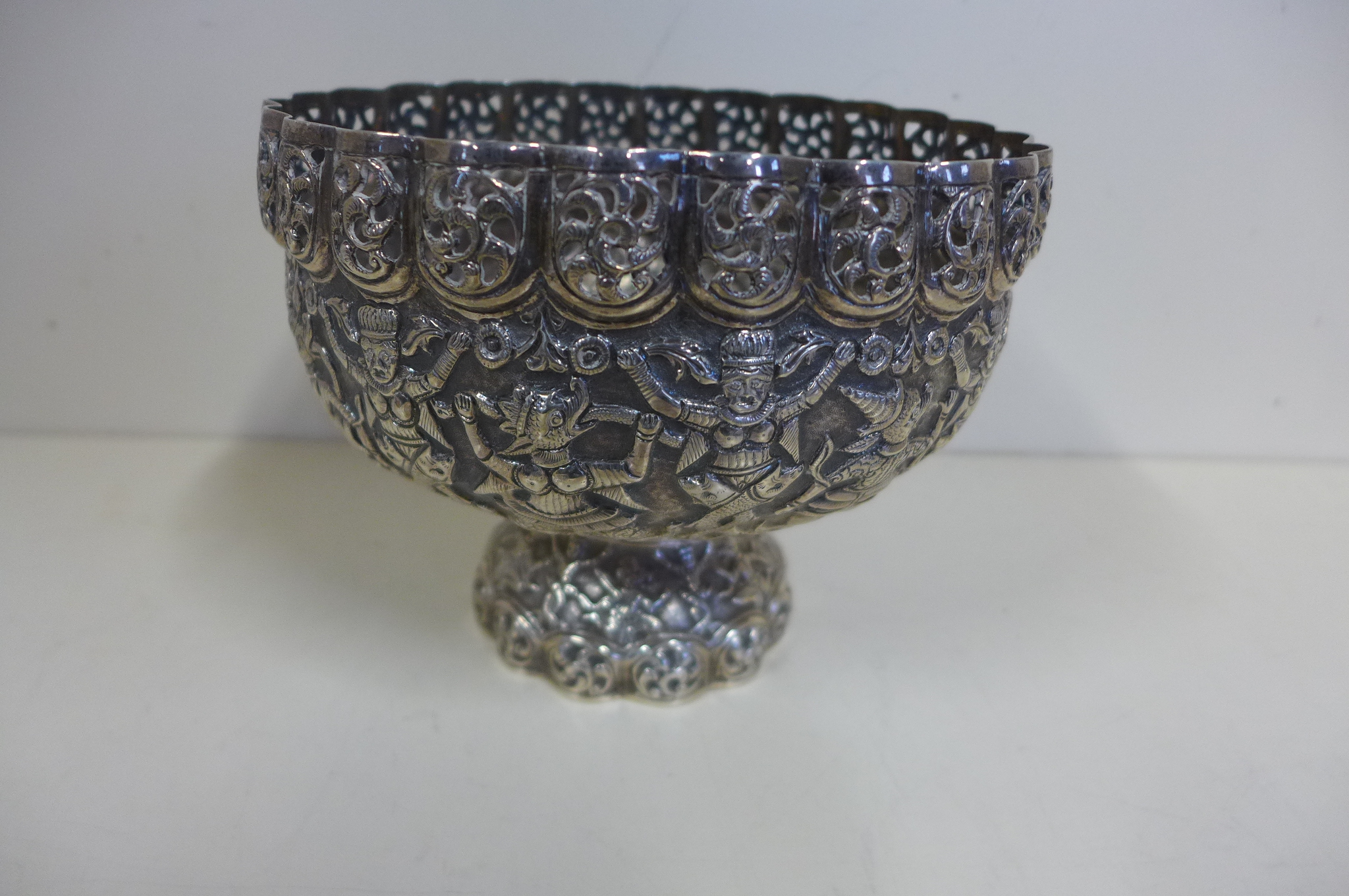 A 19th century Thai silver stem bowl decorated with mythical animals and beings, height 13.5cm,