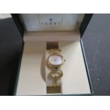 A ladies Gucci 1600 gold plated bangle wristwatch with oval case and Mother of Pearl face, simply