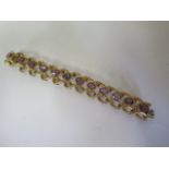 A heavy Victorian style pinchbeck and amethyst open weave bracelet, length 18cm, some wear to