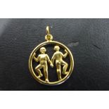 An 18ct gold zodiac pendant gemini, approx weight 3 grams, diameter 20mm, stamped 750 and tested,