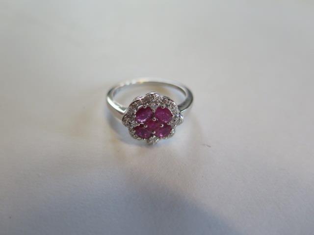 A 14ct white gold four stone ruby and diamond ring, size N, approx 2.9 grams, in good condition