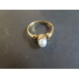 An 18ct gold ring set with a single baroque pearl in a collett setting, pearl approx 6mm in
