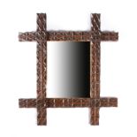 A Victorian folk art chip carved wall mirror, the rectangular plate within a painted frame to