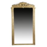 A French giltwood and composition pier mirror in Louis XV style, the arched plate within a leaf