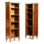 A pair of French mahogany open bibliotheques in Louis XVI style, each with a gilt brass pierced