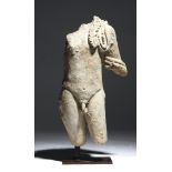 A Romano-Egyptian limestone torso of Harpocrates, c.1st - 2nd century AD, the youthful god