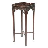 A mahogany urn stand in Chinese Chippendale style, with an undulating pierced quatrefoil gallery,