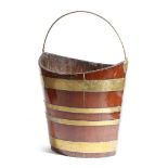 A 19th century mahogany and brass bound peat bucket, of navette shape, with a brass swing handle,