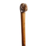 Two Victorian folk art walking canes, one of gnarly rootwood, with a bulbous handle, the other