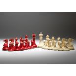 λ A Victorian ivory Staunton pattern part chess set, natural and stained red, (one rook replaced),