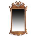 A George II walnut and parcel gilt fret-frame wall mirror, the rectangular plate with cusped top