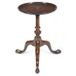 A George II mahogany kettle stand, the dished top on a turned and fluted stem on cabriole legs and