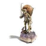 A 19th century gilt metal pin cushion, in the form of a well dressed monkey carrying a lantern and