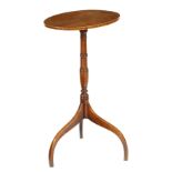 λ A Regency rosewood tripod wine table, the oval tilt-top on a ring turned baluster stem and scroll