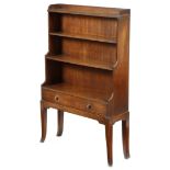 A mahogany waterfall open bookcase in Regency style, with reeded mouldings, the base with a