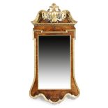 A George II style walnut and parcel gilt wall mirror, the later rectangular bevelled plate within