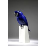 A Royal Copenhagen porcelain Art Deco style blue parrot, modelled perching on a plinth, underglaze