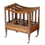 A Regency mahogany Canterbury, with four divisions and a drawer, on turned legs and brass castors,