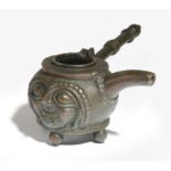 An Italian bronze spirit warmer, with a turned and faceted handle, with a bulbous body decorated