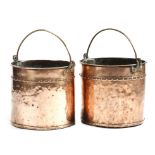 A matched pair of 19th century copper logbins, each with a brass swing handle and a riveted body,