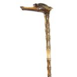 λ A late Victorian sectional horn walking cane, the handle carved with a greyhound head,
