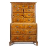 A George II walnut chest on chest, with three short and six long cross and feather banded drawers,