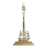 A Victorian brass 'Nelson' doorstop, in the form of H.M.S. Victory, the pierced handle with a