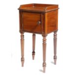 λ A George IV mahogany bedside cupboard attributed to Gillows, with a reeded three quarter gallery