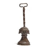 A Victorian patinated bronze wheatsheaf doorstop, with an open handle, on a reeded leaf decorated