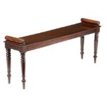 A 19th century mahogany hall bench, with a pair of bolster lifts, on turned tapering legs, 49cm