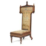 λ An early Victorian rosewood Gothic style prie dieu, carved with oak leaves, pinnacles