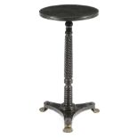 A George IV ebonised occasional table, the circular fixed top with a reeded edge on a spiral