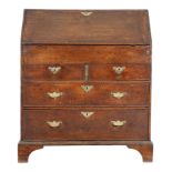 A George II oak bureau, the hinged fall revealing pigeonholes and drawers, with a central cupboard