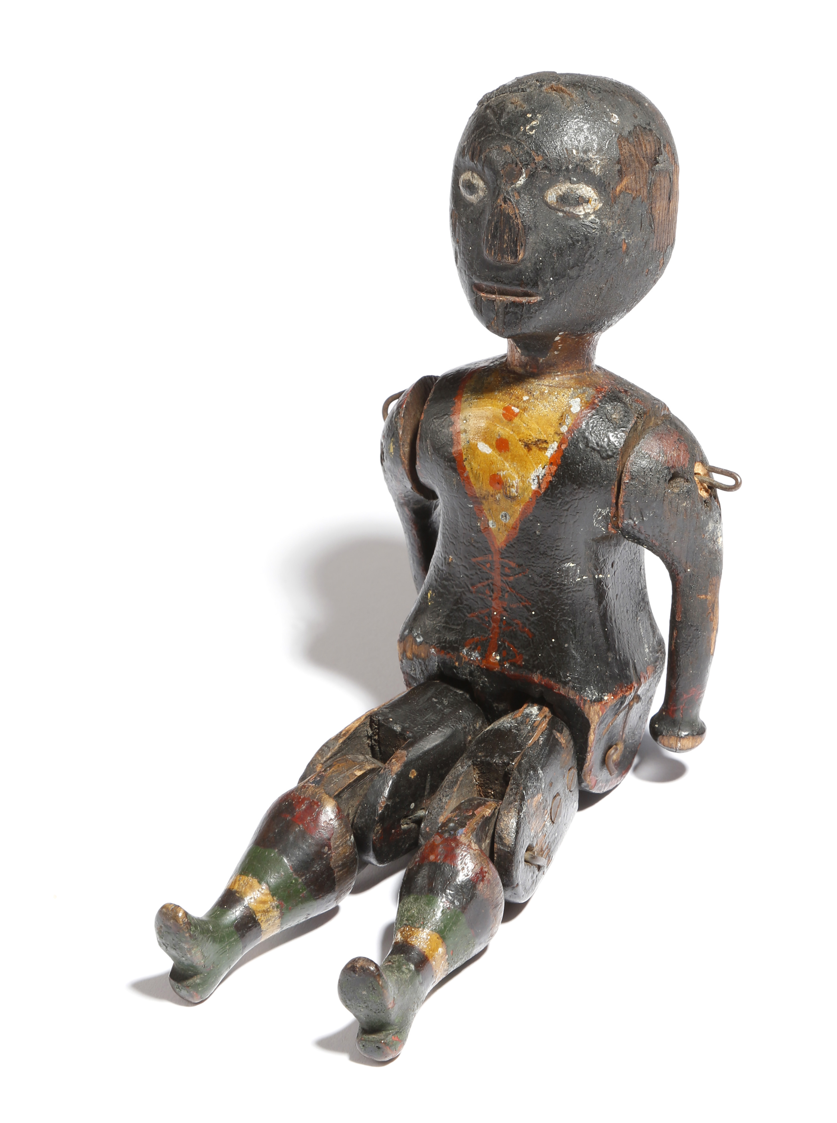 A late 19th century American folk art painted wood jig doll, in the form of a black boy, with