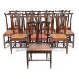 A set of twelve mahogany dining chairs in early George III style, each with a serpentine top rail,