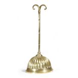 A Victorian brass doorstop, with a scroll handle and a lobed bell shaped weighted base, stamped with