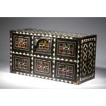 λ An Indian ebony and tortoiseshell table cabinet, inlaid with bone with geometric designs