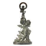 A Victorian patinated bronze doorstop, depicting a winged cherub holding a grapevine, with scrolling