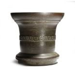 An 18th century bronze mortar by the Beadmore Foundry, the everted rim above a guilloche band of