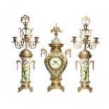 A French pottery and gilt brass clock garniture, the eight day brass cased drum movement striking on