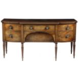 A Regency mahogany sideboard, inlaid with ebonised stringing, the top with a reel moulded edge,