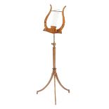 A mahogany music stand in Regency style, with a lyre support above a rest, with an adjustable