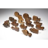 A collection of treen pulleys, of differing designs, some with chip carved decoration, 18th / 19th