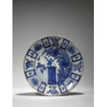 A Delft tin glazed pottery Kraak style dish, blue and white decorated with a central scene of an