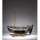 A folk art painted wood model crab boat shop sign, with three oars, two crab pots and nets,