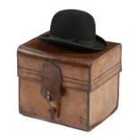 A leather top and bowler hat box, with brass mounts, impressed with initials 'C. P. J.',