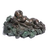 A 19th century Russian bronze model of a sleeping putto, resting on a draped cross with a grapevine,